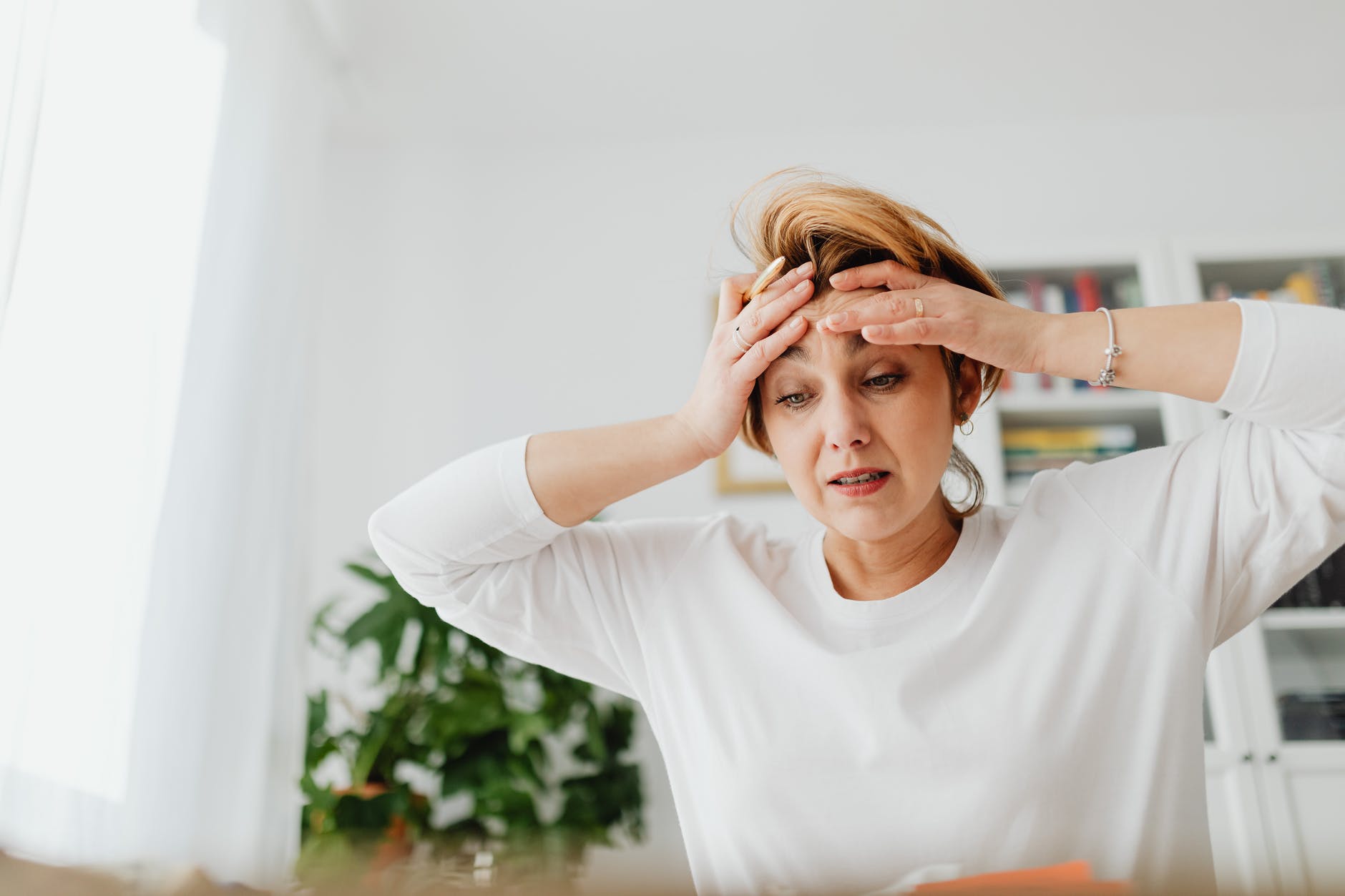 worried woman holding her hands on her forehead
